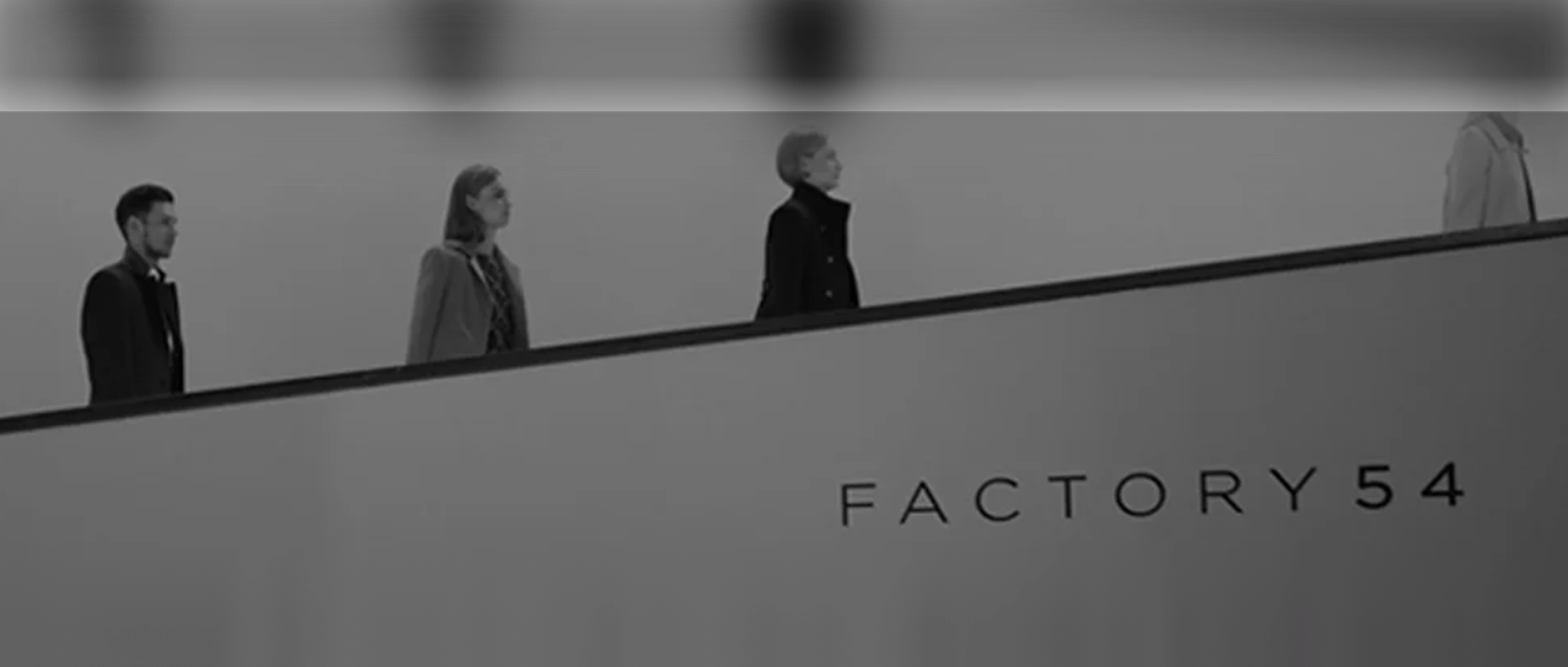 Factory 54: customers riding the escalator past the store wordmark
